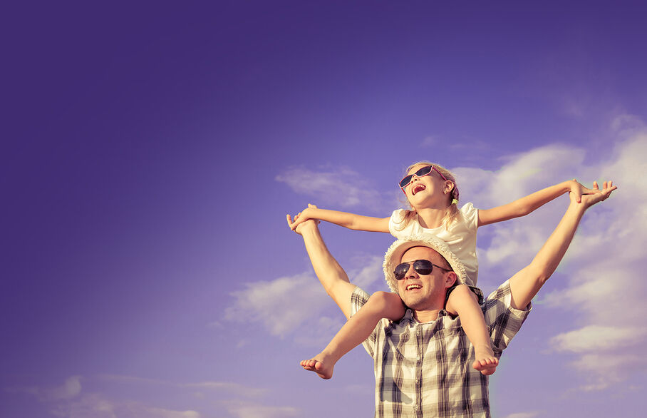 child on dads shoulders